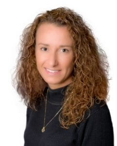 A professional portrait of Linda Fliss smiling, wearing a black shirt.